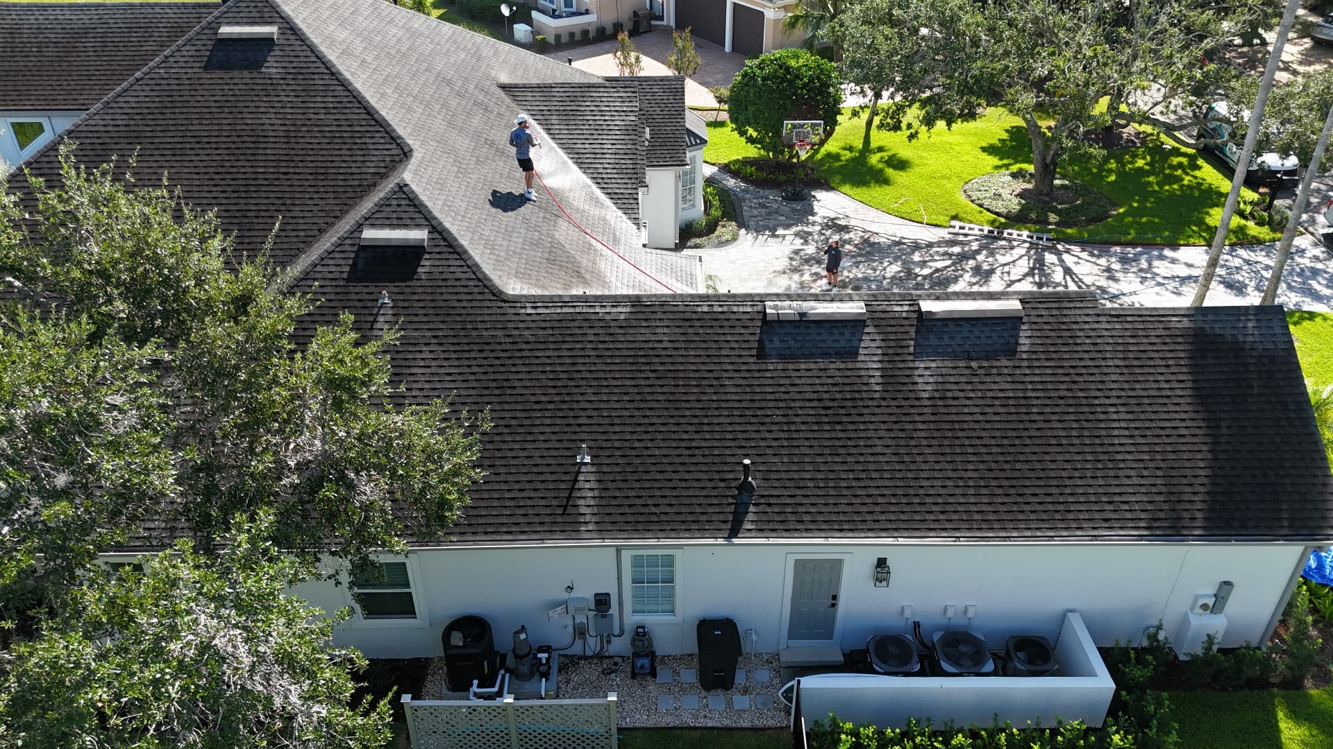 Roof before cleaning — dark algae streaks across shingles