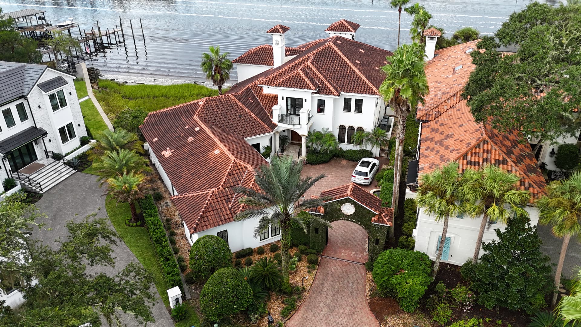 Tile roof before cleaning — dark algae and weathering visible across the roof